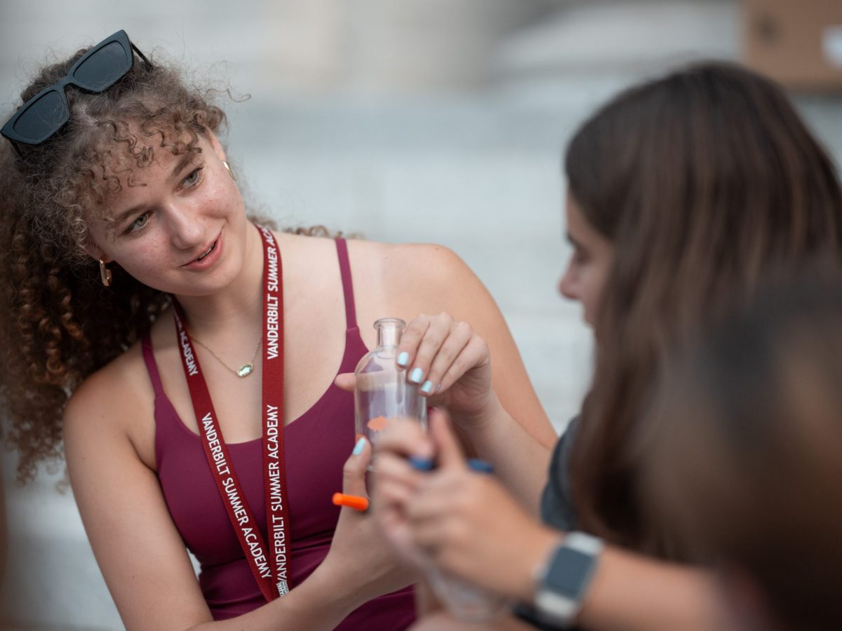 Student from VSA precollege summer course etches glass for project.